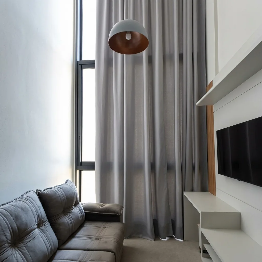 Cortinas do teto ao chão em sala de pé-direito duplo